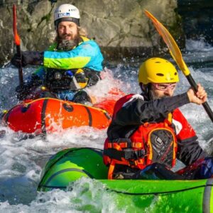 Avventura di packrafting sul Torrente Lima in Toscana: due persone affrontano le rapide in gommoni monoposto.